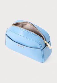 Light blue leather cosmetic bag with a gold zipper and a subtle texture. Features a front pocket for additional storage. Rectangular shape.