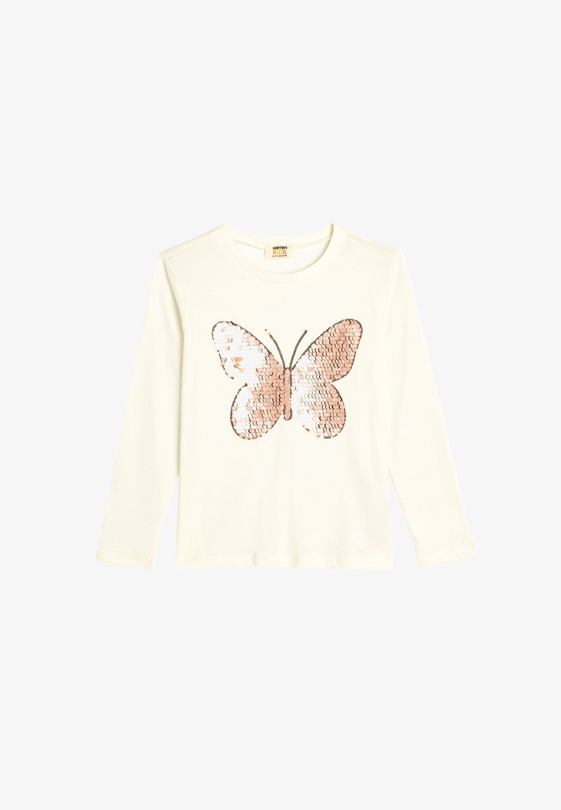 Long-sleeve cream T-shirt featuring a large, sequined butterfly design in shades of pink and silver on the front. Soft cotton material.