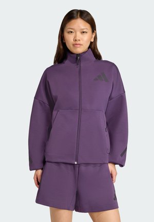 Purple zip-up jacket with matching shorts, made of textured fabric; features a high collar and black accents, including a logo on the chest.