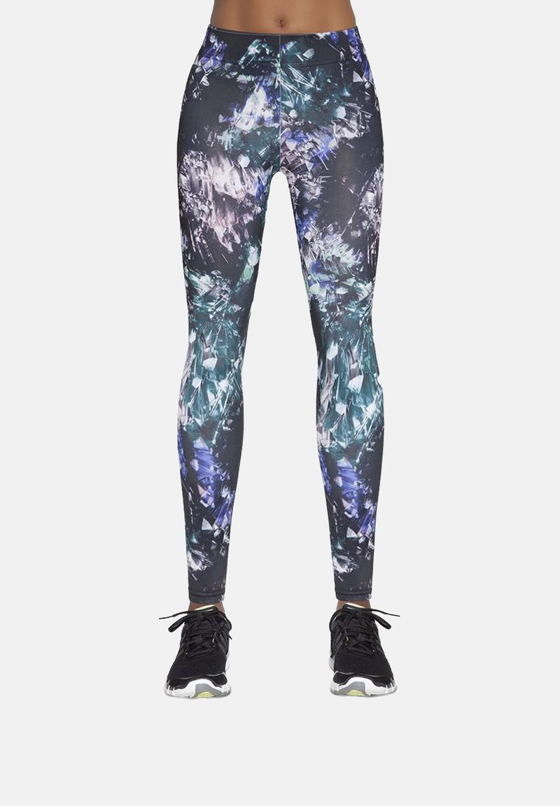 Kolorowe legginsy dopasowane, z abstrakcyjnym wzorem kryształów w czerni, morskim i fioletowym. Gładka tkanina i elastyczny pas.