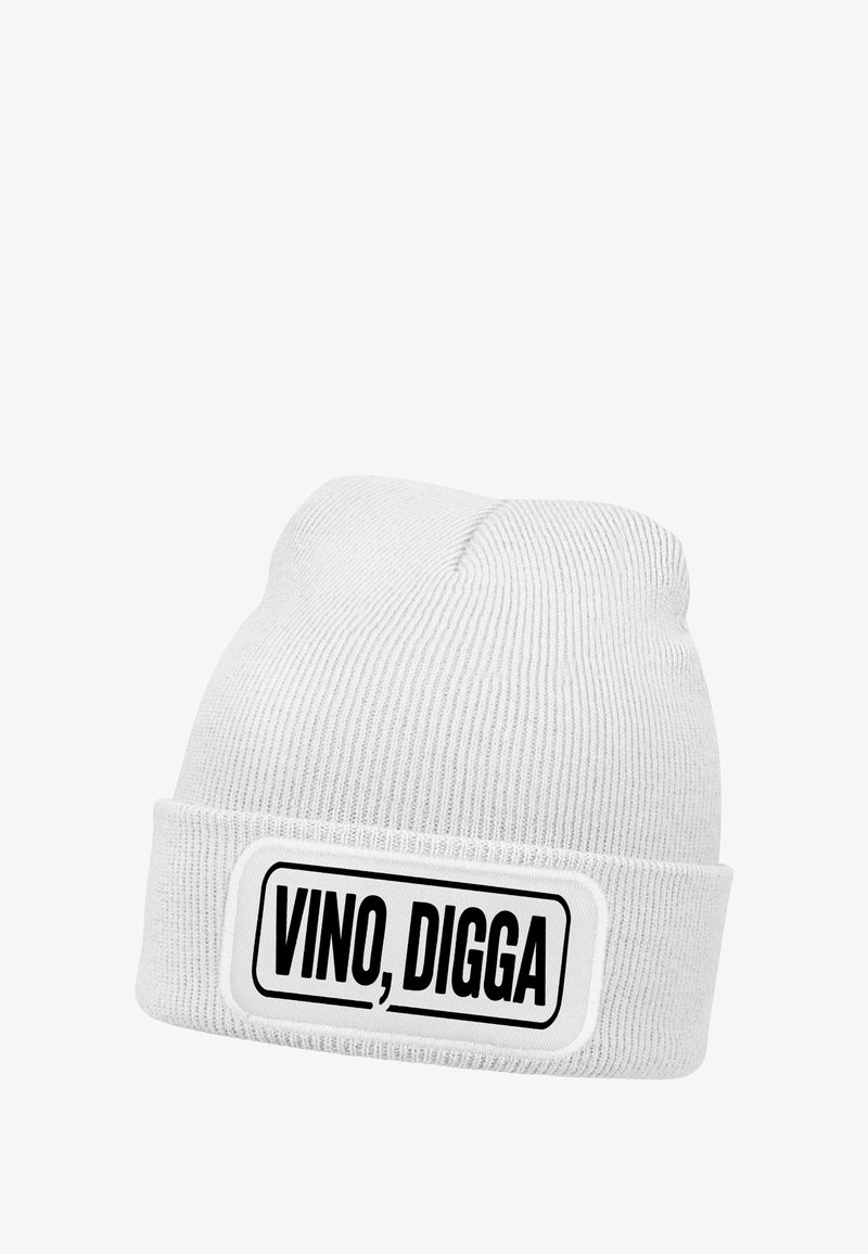 White knit beanie with a folded cuff featuring a rectangular patch that reads "VINO, DIGGA" in bold black letters.