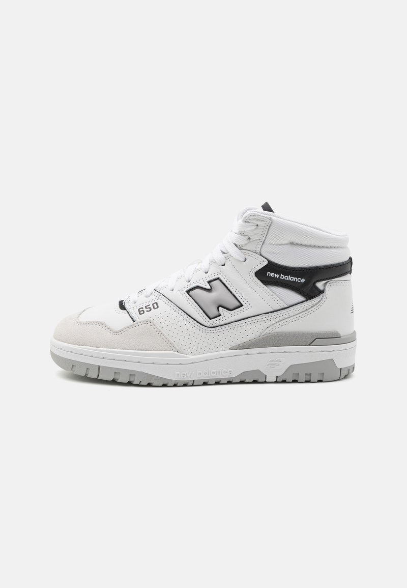 Mid-top athletic shoe in white leather and grey suede, featuring a perforated design, black accents, and a grey rubber outsole.