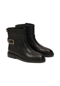 Black leather ankle boots with a smooth texture, rounded toe, and a flat heel. Features a wide strap with a rectangular gold buckle.