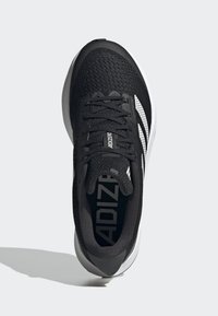 Black athletic shoe with a breathable mesh upper, white accent stripes, and a cushioned sole. Features traditional lacing and logo.