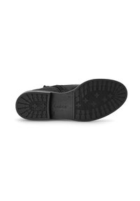 Black shoe sole with textured rubber grip featuring a zigzag pattern. Includes embossed brand name "Gabor" on the bottom surface.