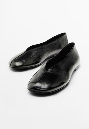 Scarpe tipo ballerina nere in pelle lucida, con un design senza cuciture, un'apertura bassa sul davanti e punta rotonda.