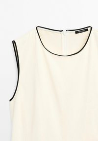 Sleevless creme kjole med sort kant rundt halsudskæringen og armhulerne, med en lynlås i ryggen og "Massimo Dutti" label.