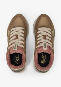 Brown sneakers with fabric upper, beige laces, and pink fluffy lining. Features gold accents and logos on insoles, rounded toe design.