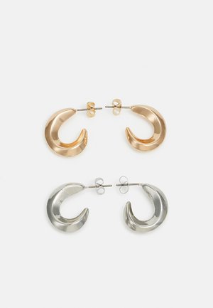 Gold and silver metallic crescent-shaped stud earrings with a smooth finish and distinctive shine, featuring a secure post back closure.