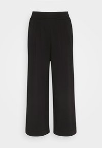 Svart vida byxor tillverkade av ett mjukt material. Har en ribbad elastisk midja och två framfållar för extra designdetaljer.