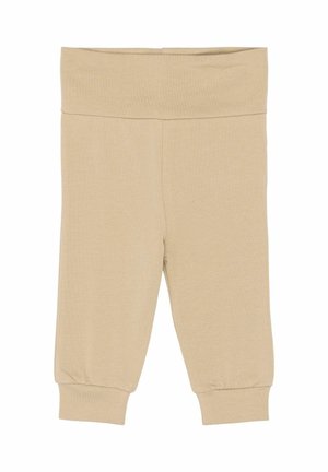 Béžové legíny vyrobené z mäkkej, pružnej bavlnenej zmesi. Majú široký pás a elastické manžety na členkoch. Celkovo hladká textúra.
