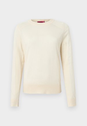 Kreminės spalvos megztinis su ilgomis rankovėmis, su briaunota faktūra rankogaliuose ir apačioje, apvaliu kaklu. Lygus audinys ir minimalistinis dizainas.