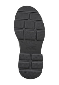Semelle d'une chaussure noire avec des motifs de bande de roulement rectangulaires et le nom de la marque Buffallo embossé près de la zone du talon.