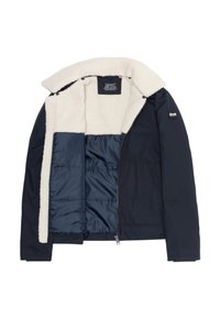 Granatowa kurtka z puszystym kremowym kołnierzem i podszyciem. Posiada zamek błyskawiczny, boczne kieszenie oraz wewnętrzną pikowaną podszewkę.