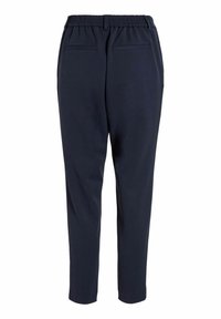 Pantalon bleu marine avec ceinture élastique, jambe fuselée et deux poches arrière. Tissu lisse et lignes épurées. Design classique pour une grande polyvalence.