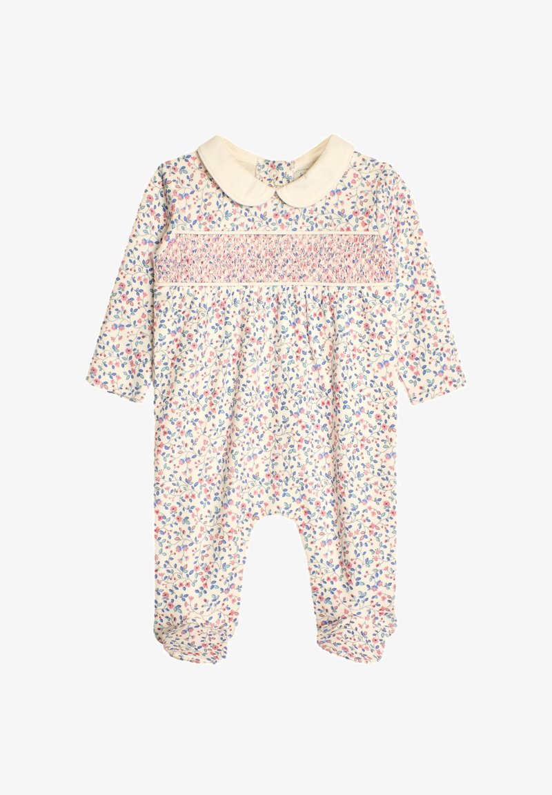 Grenouillère bébé à manches longues avec motif floral, panneau poitrine smocké et col Peter Pan crème sur fond blanc.