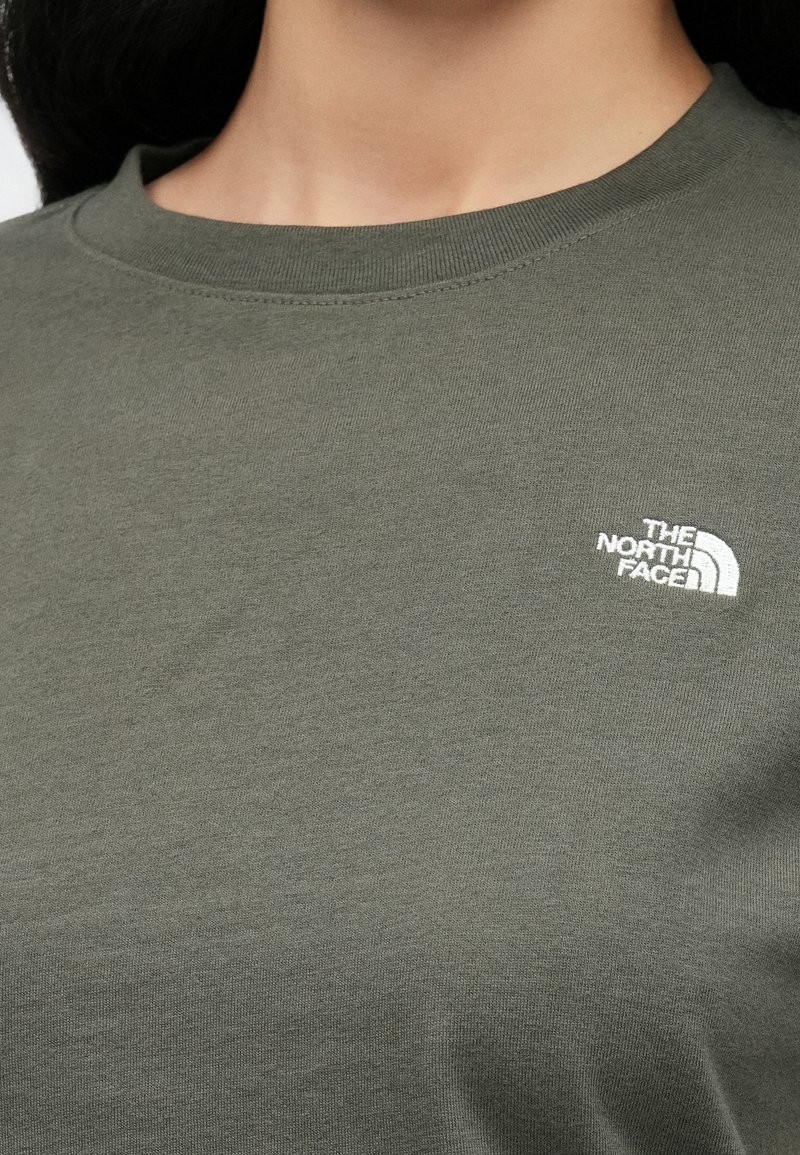 Olive green cotton t-shirt with a crew neckline. Features a small white logo of "The North Face" on the upper left side.