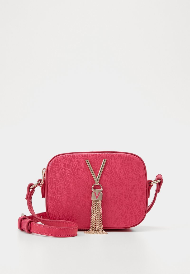 Pink textured leather handbag with a rectangular shape, gold hardware, V-shaped accent, and a chain tassel detail. Adjustable shoulder strap.