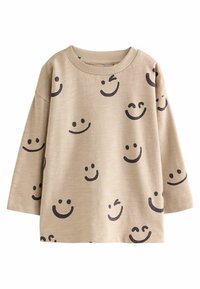 Beige langærmet skjorte med forskellige sorte smiley ansigt tryk, med ribbet halsudskæring og blødt, tekstureret stof.