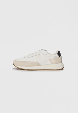 Sneakers with a white leather and light beige suede upper, featuring a sleek design, round toe, and a minimalistic gum sole.