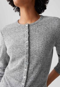 Gray knitted cardigan with a round neckline and seven shiny buttons down the front. Features a textured fabric and three-quarter sleeves.