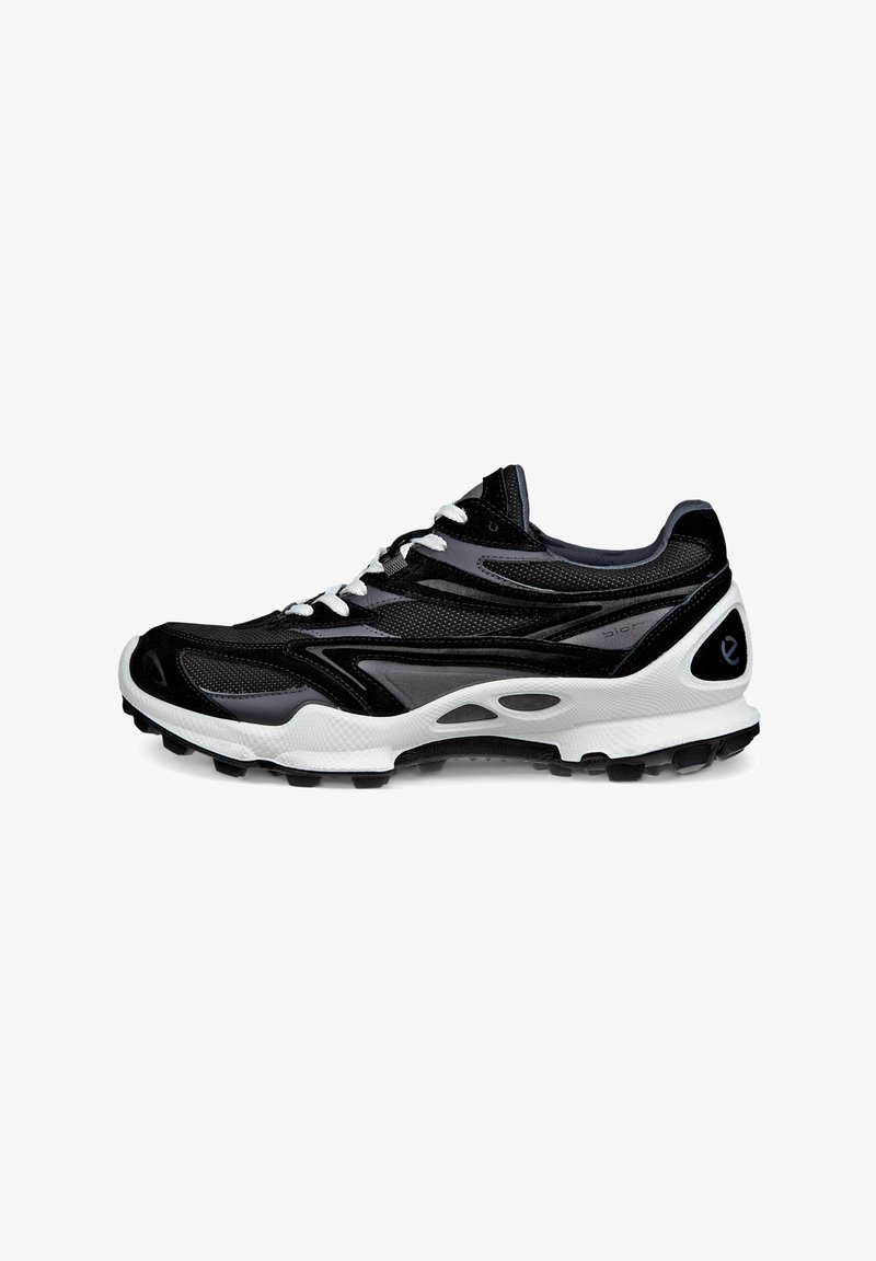 Black athletic shoe with mesh and synthetic materials, white sole, contrasting textures, and lace-up design. Features cut-out accents on sides.