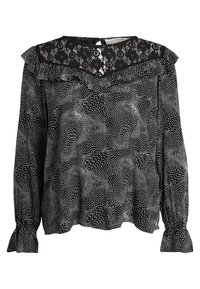 Blusa nera con motivo a pois bianchi, dettaglio in pizzo sul collo, maniche lunghe con polsini arricciati e una vestibilità morbida.