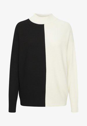 Czarny i biały sweter prążkowany z wysokim dekoltem; ma podzielony fason, długie rękawy i luźny krój. Teksturowany materiał na całej powierzchni.