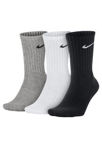 Trois paires de chaussettes de sport : grises, blanches et noires. Chacune présente une texture côtelée et un petit logo Nike en forme de virgule noir sur le côté.