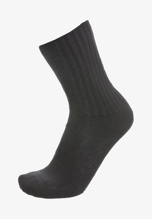 Calcetín negro de canalé hecho de material tejido, con puntera y talón reforzados, de longitud media hasta la pantorrilla y textura suave.