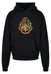 Svart hettegenser med et fargerikt Hogwarts-våpenskjold på forsiden, med gullfarger og kengurulomme. Myk tekstur.