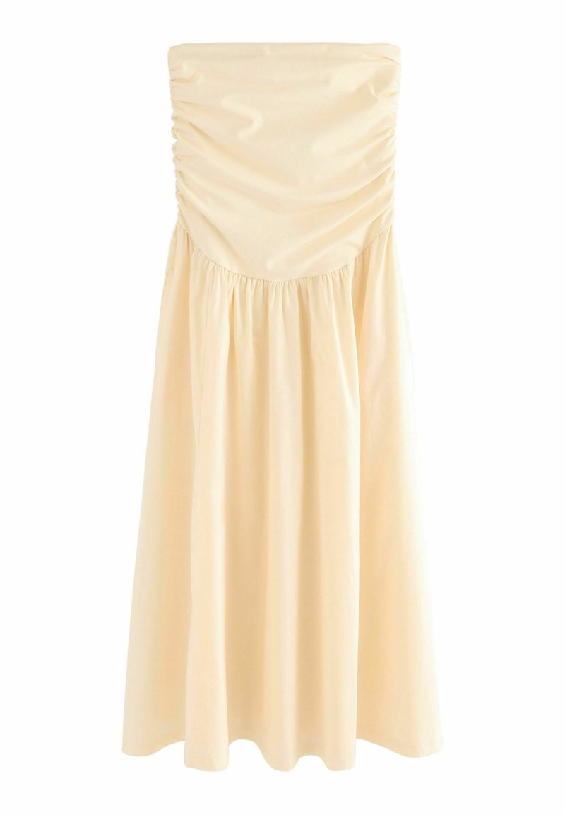 Mouwloze midi-jurk in lichtbeige, met ruches bij het lijfje en een gathered rok voor een vloeiende uitstraling. Glad, lichtgewicht stof.
