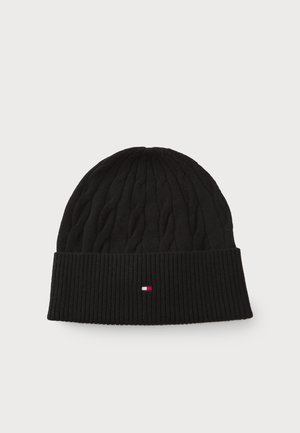 Black knitted beanie featuring a cable knit pattern, a ribbed cuff, and a small embroidered logo in red, white, and blue on the front.