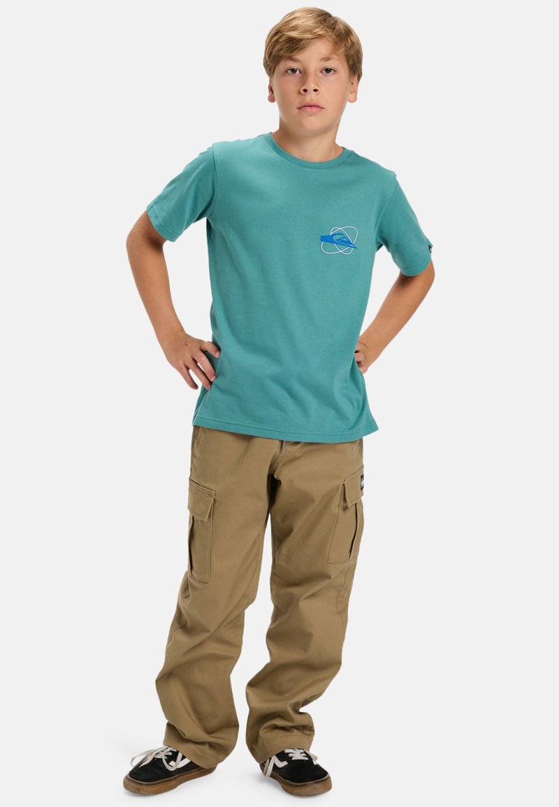Turquoise cotton t-shirt with a blue graphic on the chest, paired with khaki cargo pants featuring multiple pockets and a relaxed fit.