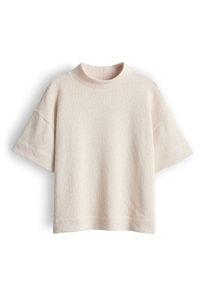 Maglione corto a maniche corte beige lavorato a maglia con collo alto rotondo e vestibilità rilassata.
