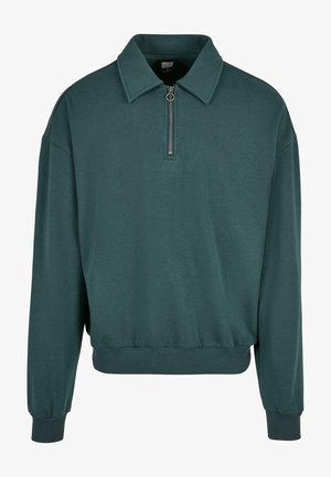 Polo-tyylinen collegepaita tumman turkoosina, jossa on puoliveto-aukko edessä, ribbireunat ja rento malli. Pehmeää puuvillakangasta.