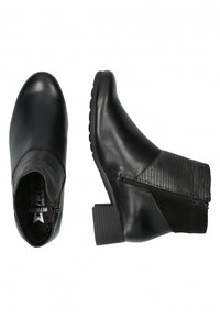 Bottines noires avec une finition en cuir lisse, fermeture éclair, talon carré et accents texturés sur les côtés. Semelle en caoutchouc pour une meilleure adhérence.
