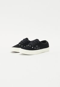 Black suede sneakers with white rubber soles, adorned with silver studs on the upper, featuring a lace-up design and padded collar.