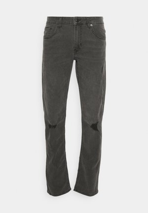 Black distressed jeans with a straight cut, featuring two knee rips and classic five-pocket design. Made from denim fabric.