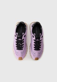 Purple sneakers with black accents, mesh upper, lace-up design, and gum rubber outsole. Features logo on tongue and heel.