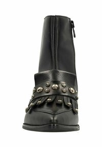Black leather ankle boot with a zip closure, featuring a decorative fringed band and round metal studs across the front. Pointed toe design.