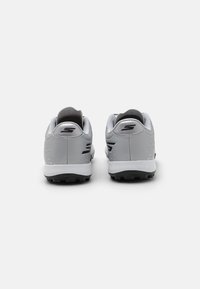Gray athletic shoes with a textured surface, black accents, and a white sole. The back features a low heel and a padded collar.