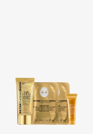 24K Gold Hautpflege-Set mit einer goldenen Tube Gesichtscreme, zwei Packungen goldener Augenmasken und einer kleinen goldenen Tube, alle mit glatten Oberflächen.