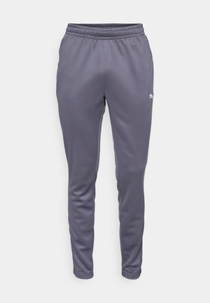 Pantalones de chándal grises con cinturilla elástica, diseño entallado y textura suave. Presenta un pequeño detalle de logo en blanco y verde.