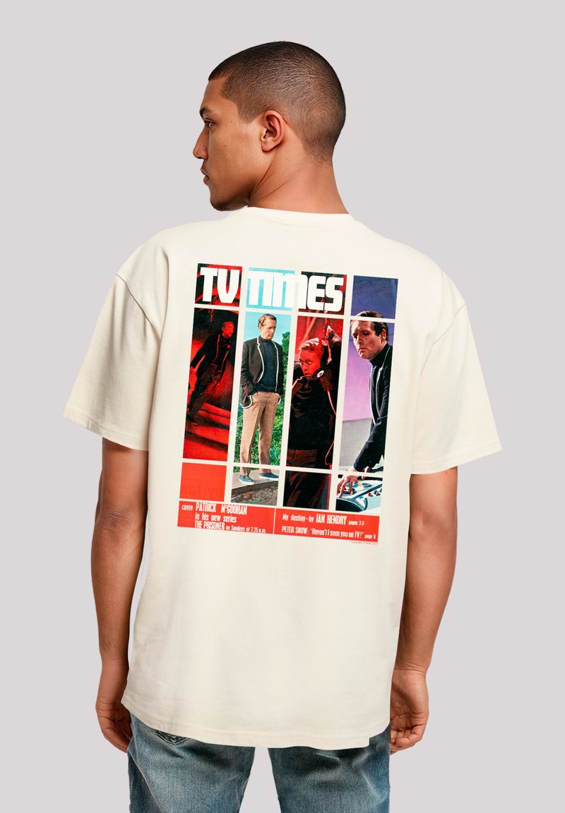 Cream short-sleeve t-shirt featuring a multicolored retro graphic print on the back, depicting characters and text in various shades.