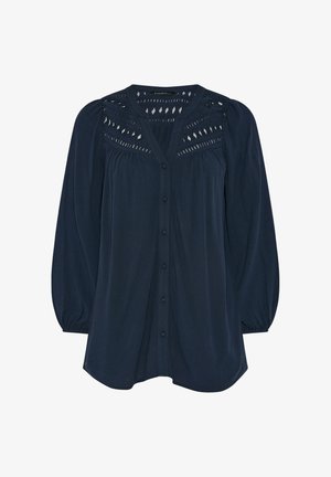 Blusa de manga larga azul marino con botones en la parte delantera, mangas abullonadas y detalles de encaje con cortes en forma de diamante en la parte superior del pecho y los hombros.
