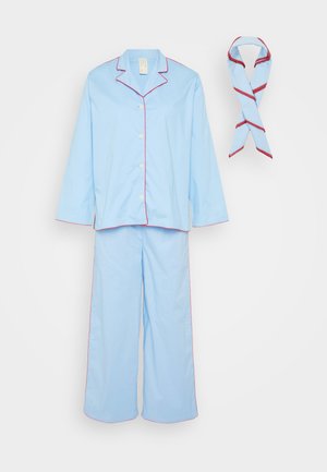 Light blue pajama set with contrasting red piping, featuring a long-sleeve button-up top and loose-fitting pants. Includes a matching scarf.