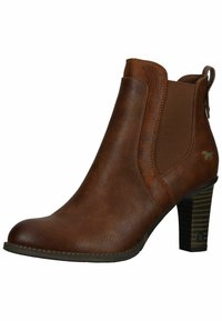 Bottine en cuir marron avec des panneaux latéraux élastiques, un design floral en relief et un haut talon empilé. Semelle texturée pour une meilleure traction.