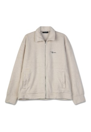 Fleece jacket in light beige, featuring a zip front, collar, two side pockets, and a stitched logo on the left chest. Soft texture throughout.