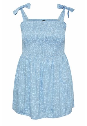 Blue dress with white polka dots, smocked bodice, and tie straps. Flared skirt with soft fabric texture, knee-length design.
